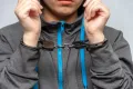 A teenage girl in handcuffs on a gray background. Juvenile delinquent, criminal liability of minors.