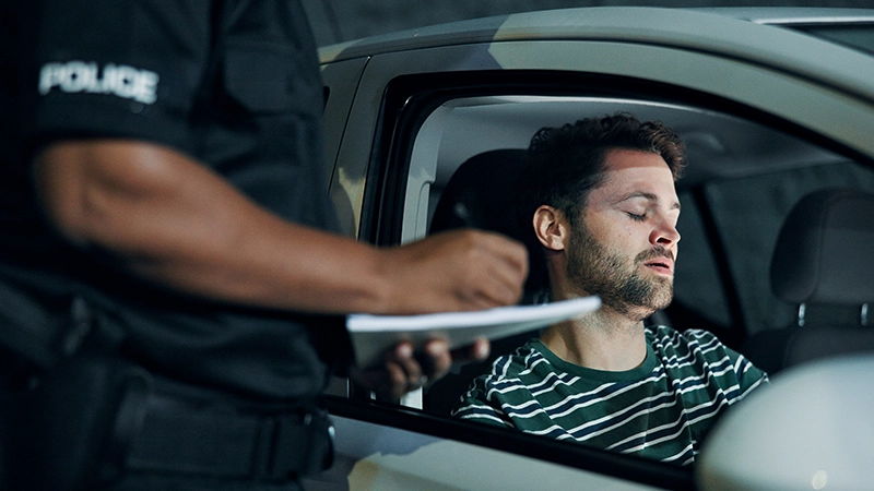 Man, police and writing of ticket fine.