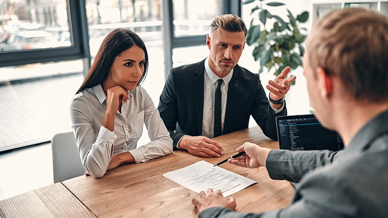 Couple signing divorce agreement.